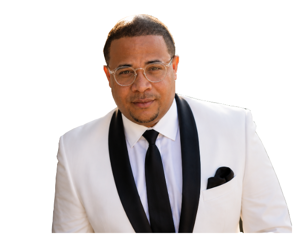 SAINT JAMES in a white dinner jacket and black tie.